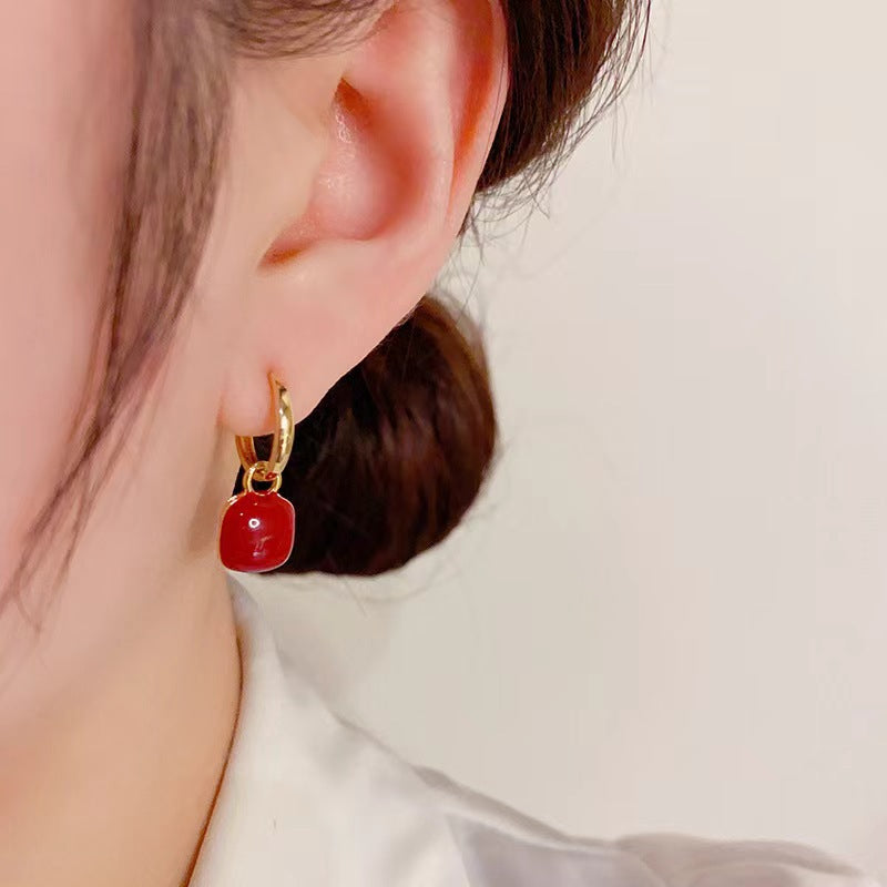 Red glazed ear clips, a rare and unique small round earring piece