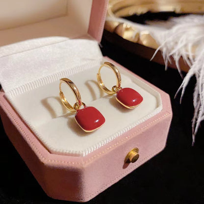 Red glazed ear clips, a rare and unique small round earring piece