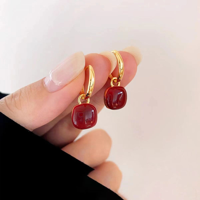 Red glazed ear clips, a rare and unique small round earring piece