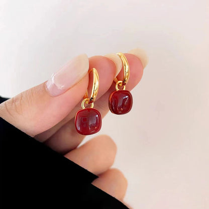 Red glazed ear clips, a rare and unique small round earring piece