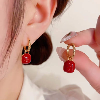 Red glazed ear clips, a rare and unique small round earring piece