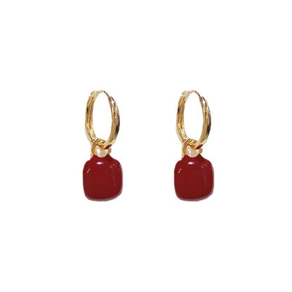 Red glazed ear clips, a rare and unique small round earring piece